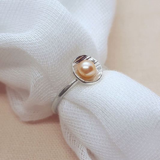 Peach freshwater pearl set in a textured silver cup ring, jewellery handmade in Kent