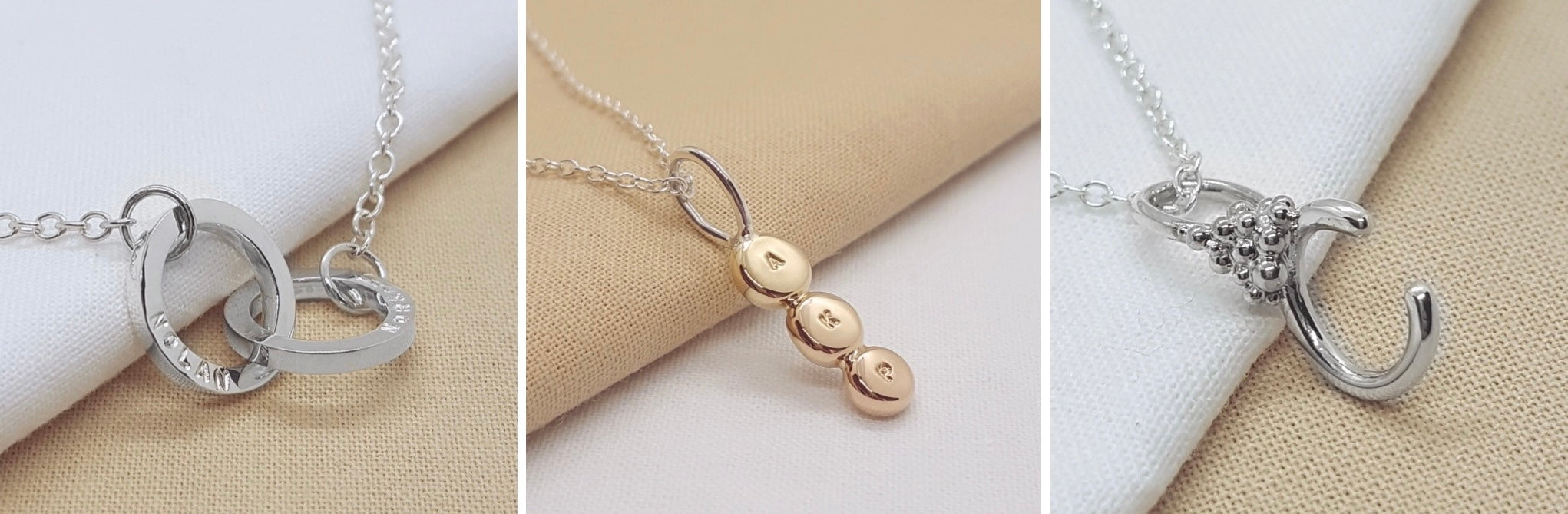 two silver interlocking circles hand stamped with names, three yellow gold discs hand stamped with initials, C silver letter necklace with silver granulation details