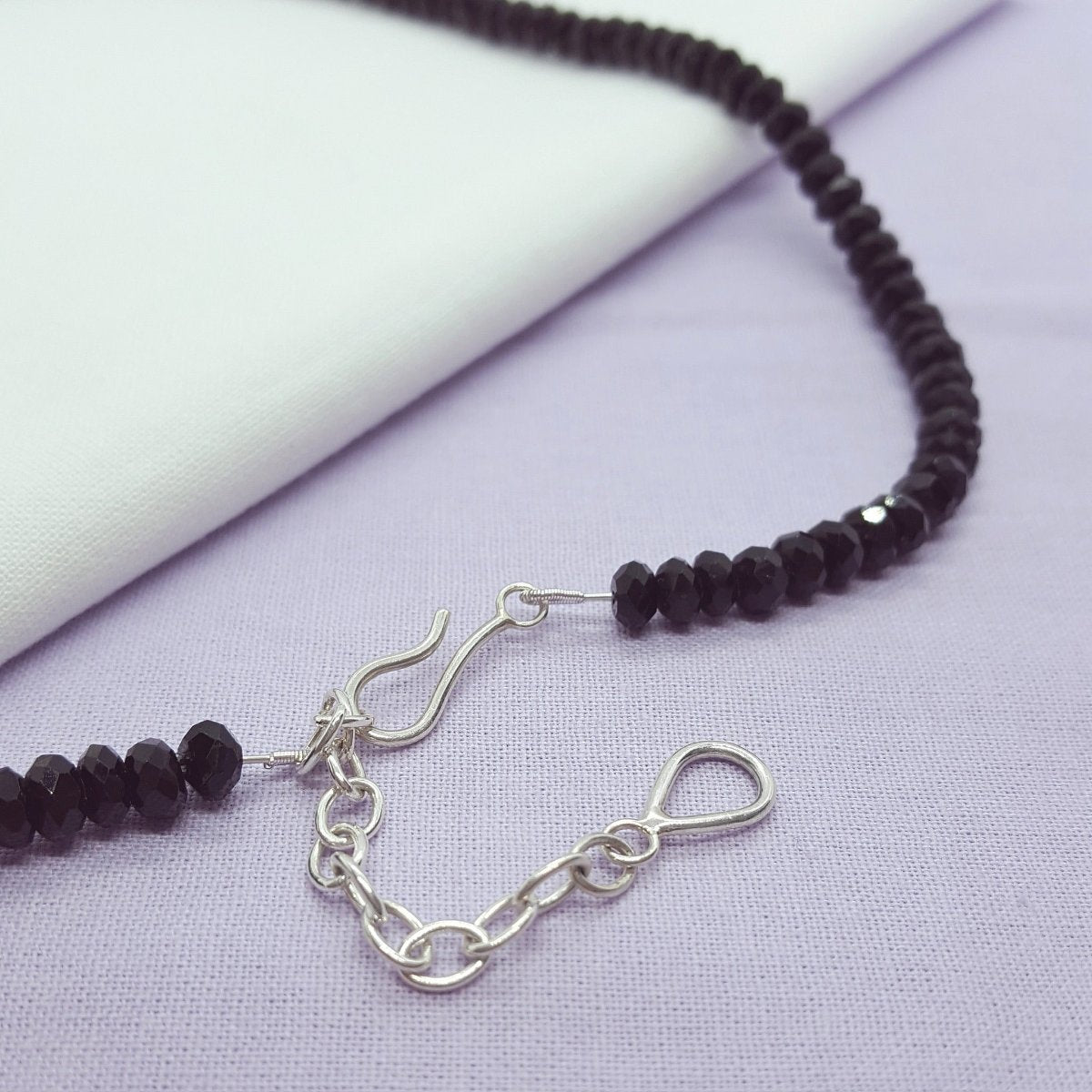 rose cut black tourmaline, set in a large textured silver disc and hung from a strand of black tourmaline faceted beads. Handmade in Kent