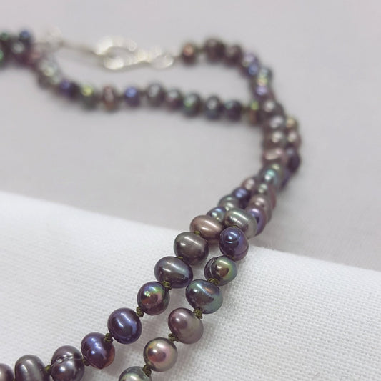 peacock freshwater pearl necklace hand knotted on olive coloured silk thread and finished with a handmade silver clasp.