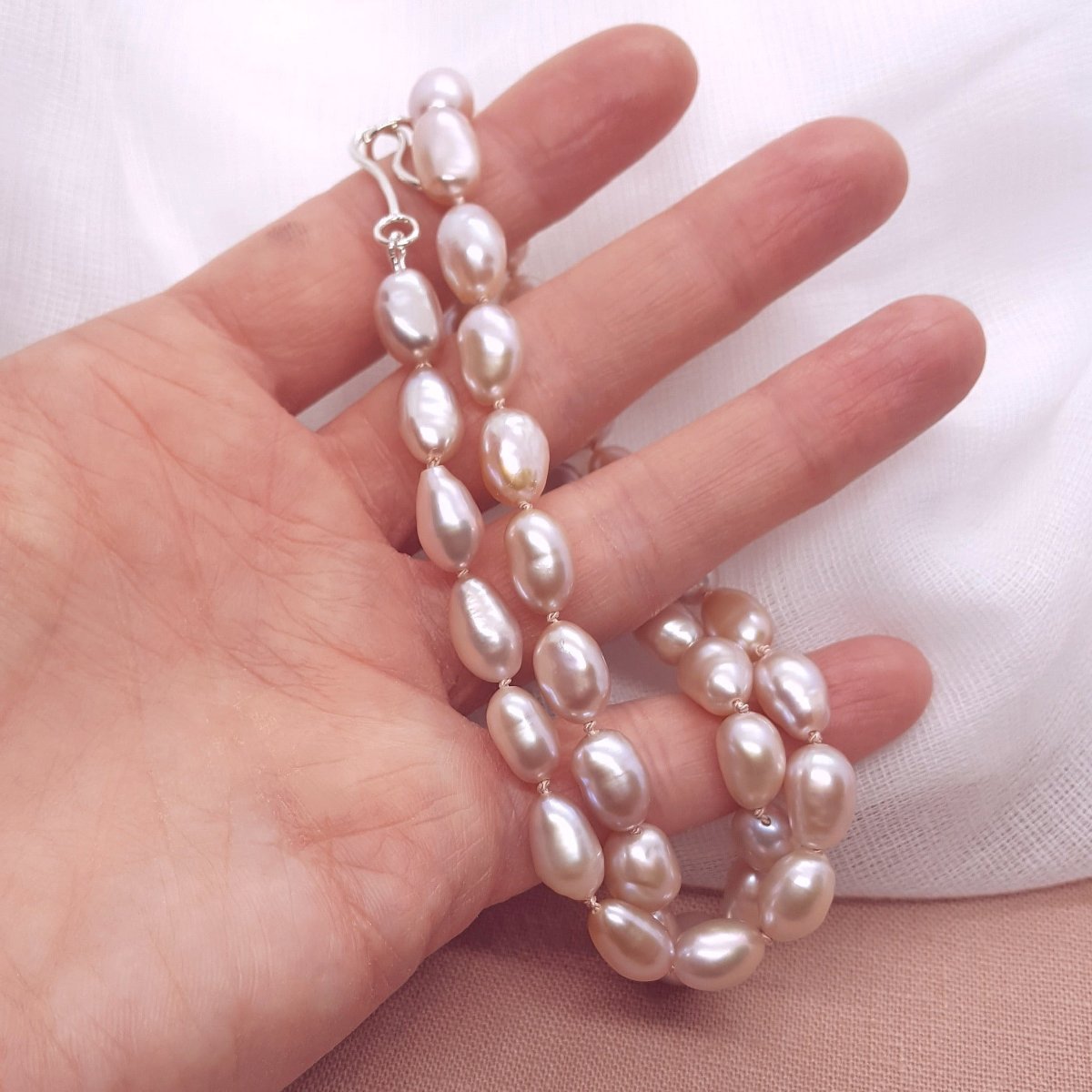 Pink oval pearl necklace, hand knotted on light pink silk thread. Handmade jewellery in the Kent countryside.