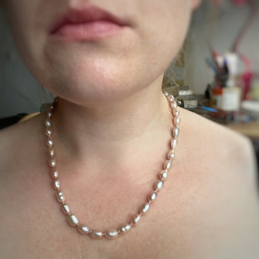 Pink oval pearl necklace, hand knotted on light pink silk thread. Handmade jewellery in the Kent countryside.
