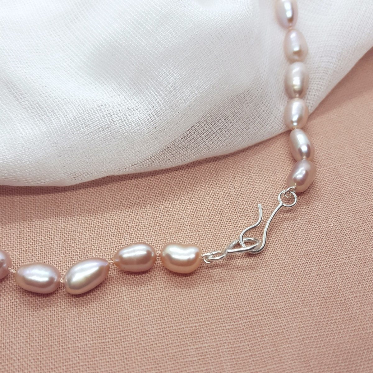 Pink oval pearl necklace, hand knotted on light pink silk thread. Handmade jewellery in the Kent countryside.