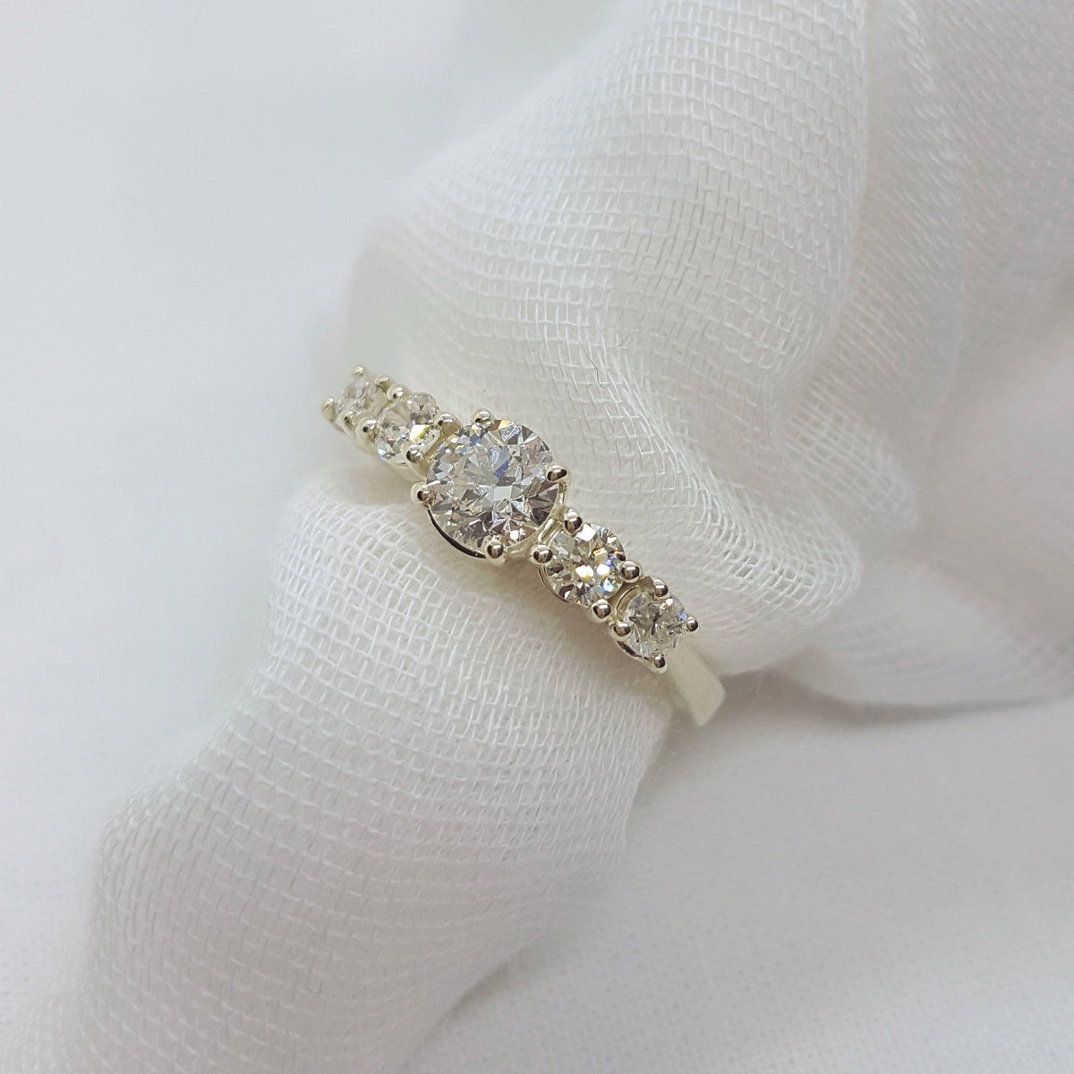 Diamond ring on a white fabric background