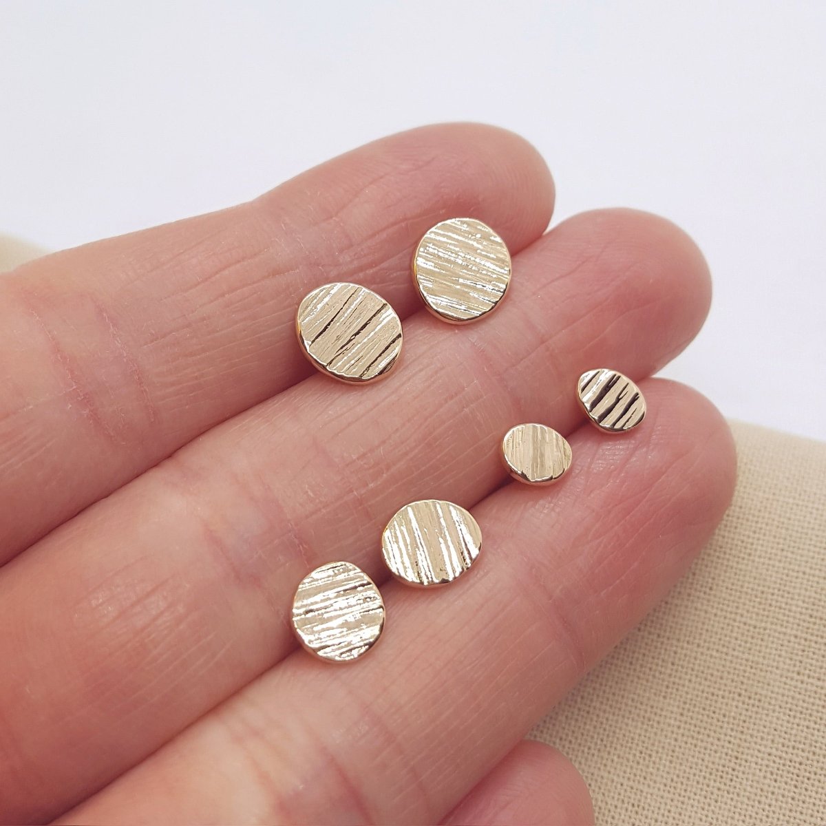 9ct yellow gold textured medium stud earrings. Handmade jewellery in Kent.