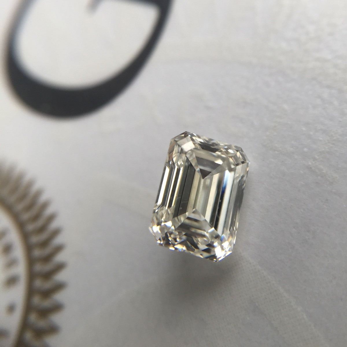 Emerald-cut diamond on a light gray background