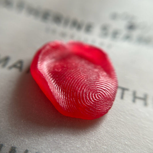 Red fingerprint on a piece of paper with text