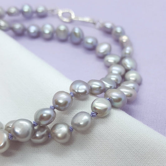 grey freshwater pearl necklace hand knotted on lilac silk thread and finished with a handmade silver clasp