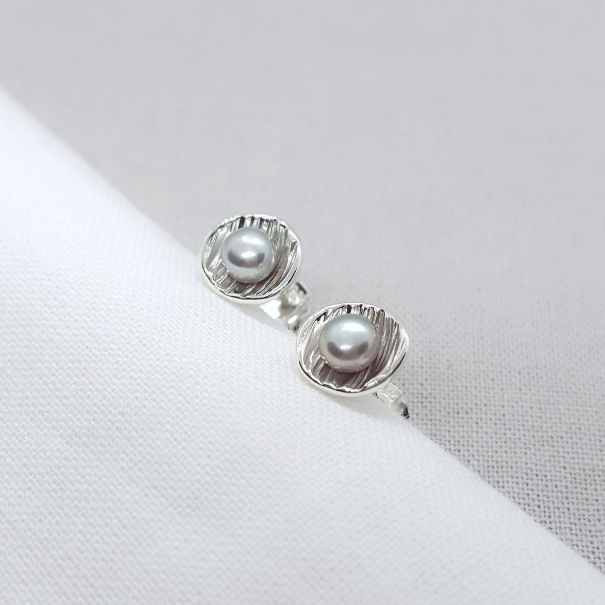 small grey freshwater pearls set in textured silver earrings, handmade in Kent