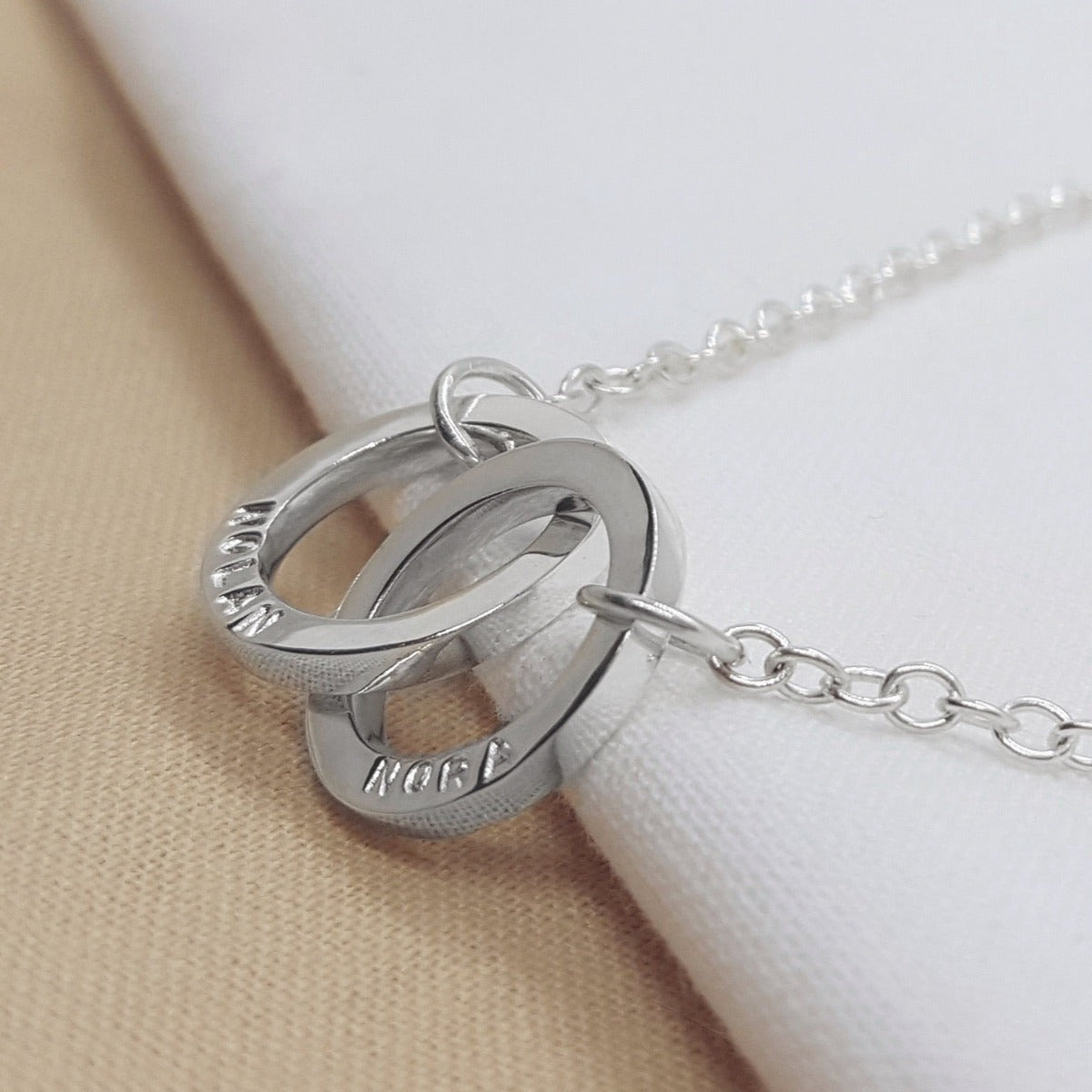 Silver interlocking circles personalised with hand stamped names