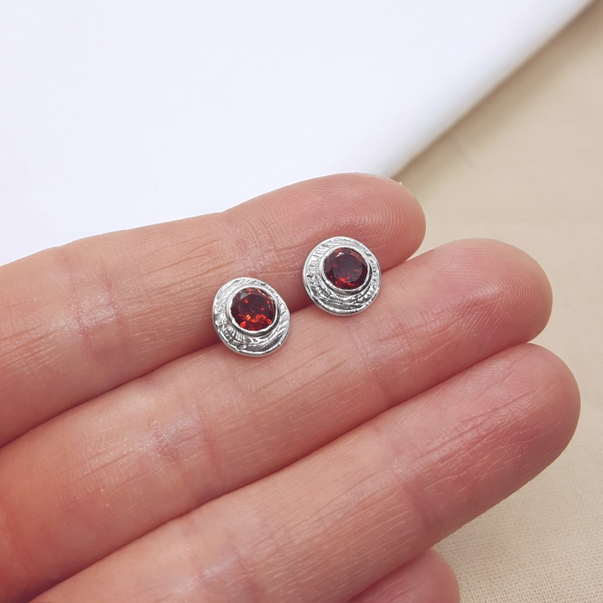 deep red Mozambique garnets set in textured silver cups. Handmade stud earrings