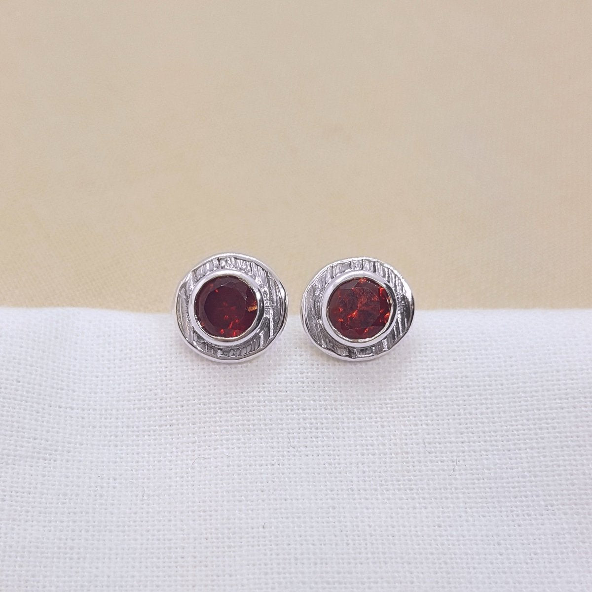 deep red Mozambique garnets set in textured silver cups. Handmade stud earrings