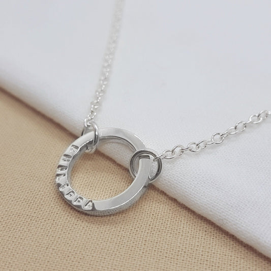 Silver circle necklace handmade with a name, date or message. Handmade in Kent