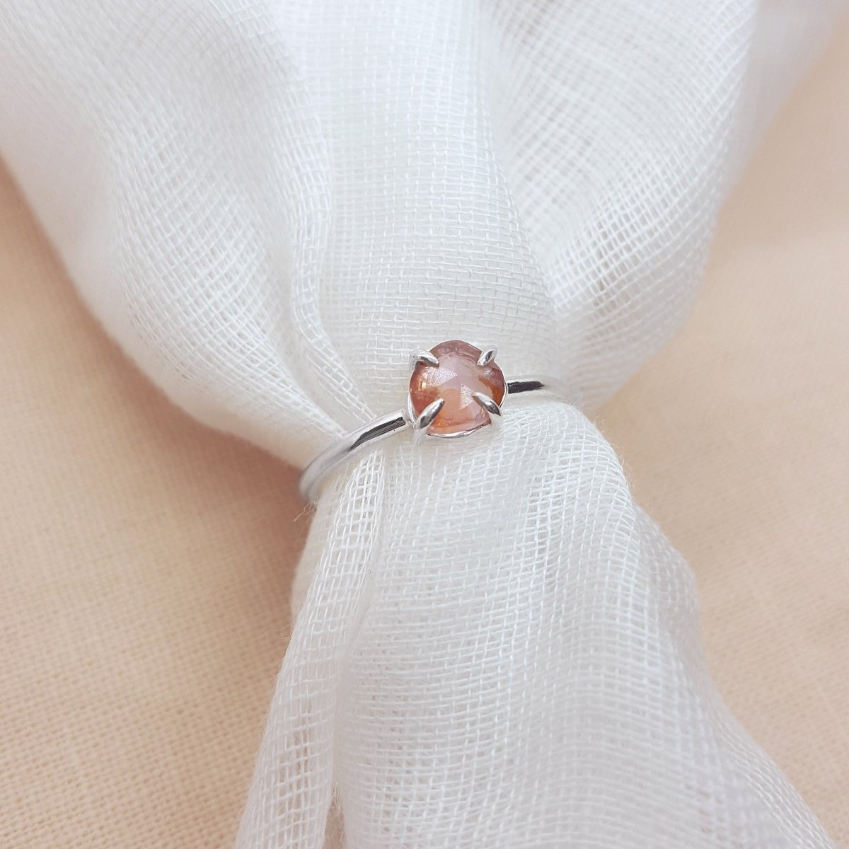 rose cut peach tourmaline set in a handmade silver ring