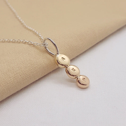 personalised hand stamped initial triple gold discs with silver bail and trace chain