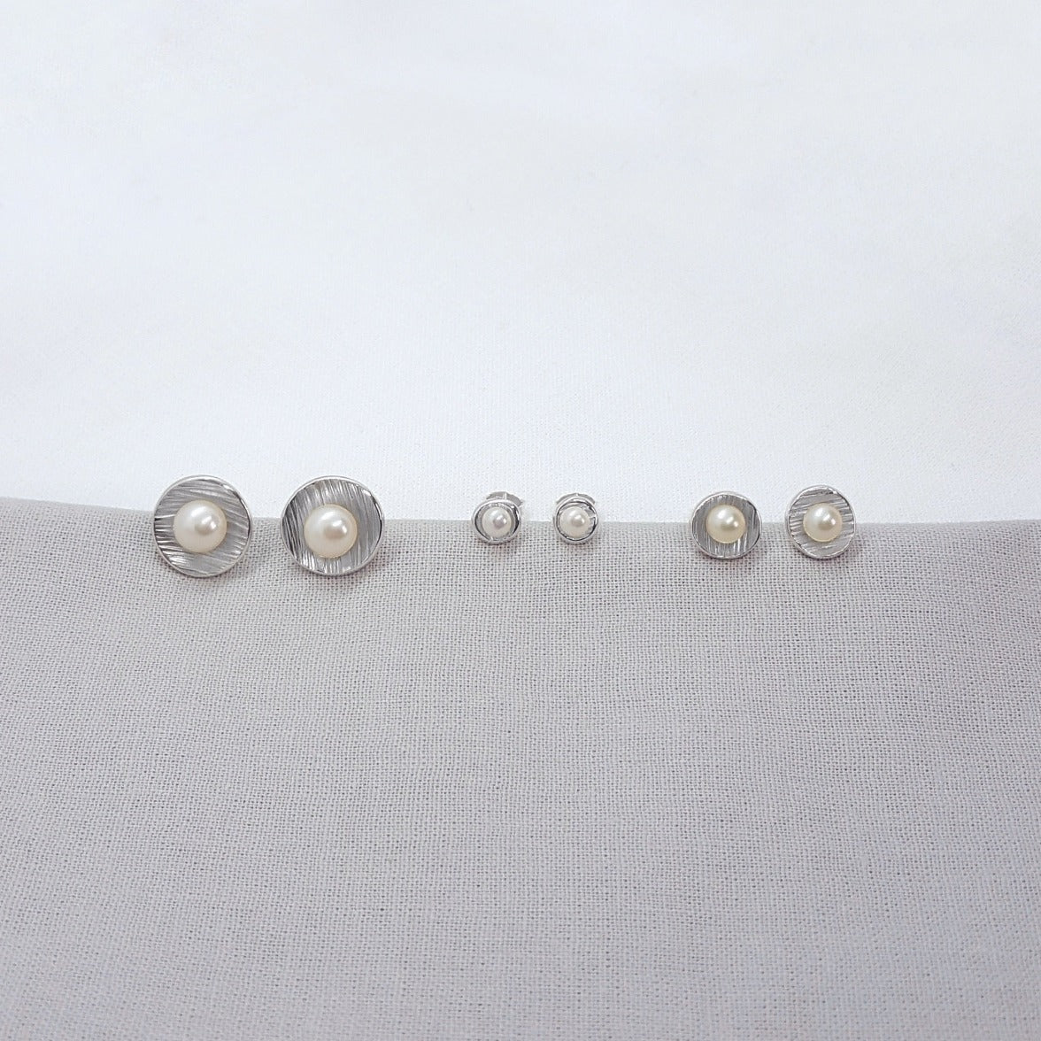 small silver handmade white freshwater pearl earrings with textured cups