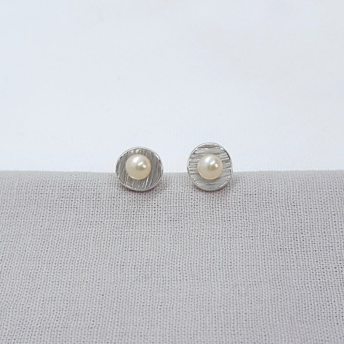 small silver handmade white freshwater pearl earrings with textured cups