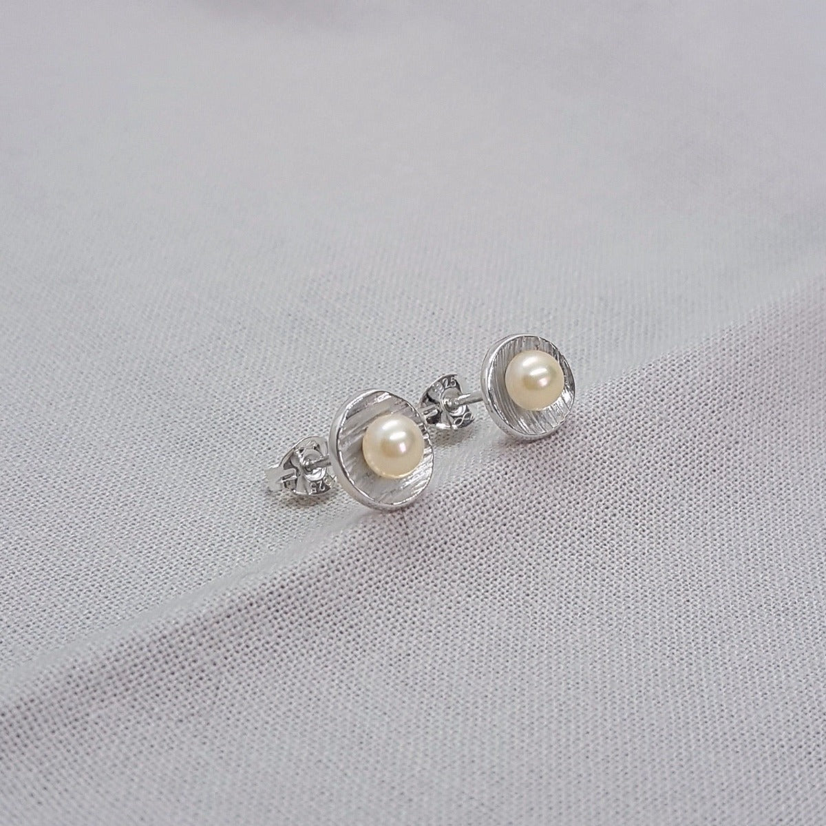 small silver handmade white freshwater pearl earrings with textured cups