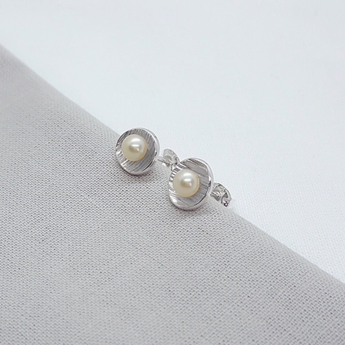 small silver handmade white freshwater pearl earrings with textured cups