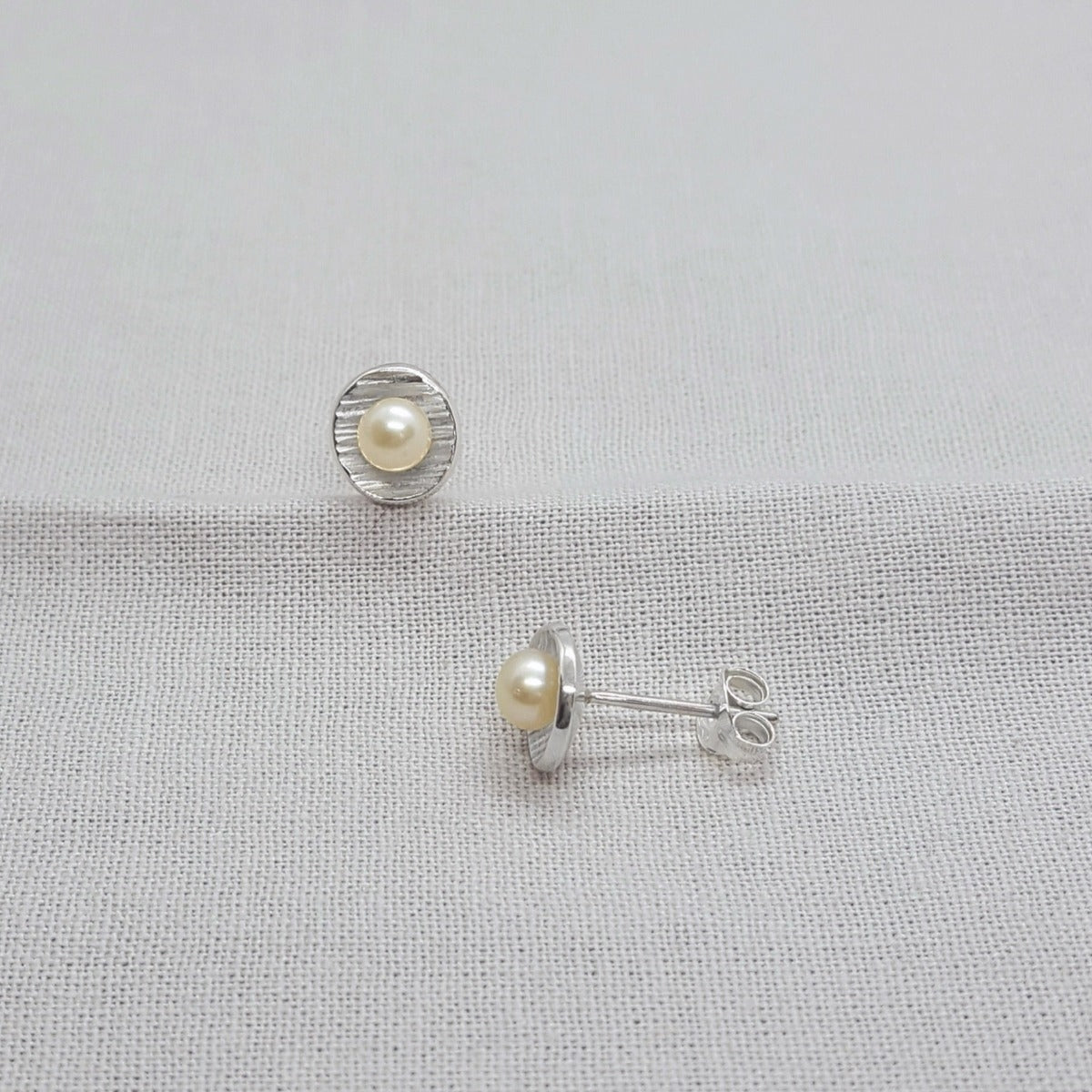 small silver handmade white freshwater pearl earrings with textured cups