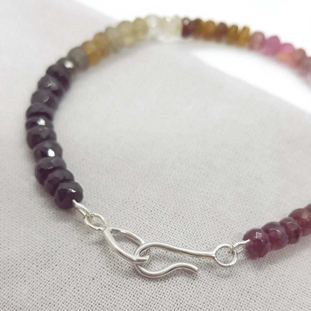 Multi coloured rondelle shaped tourmaline bracelet with a handmade silver clasp, handmade in Kent