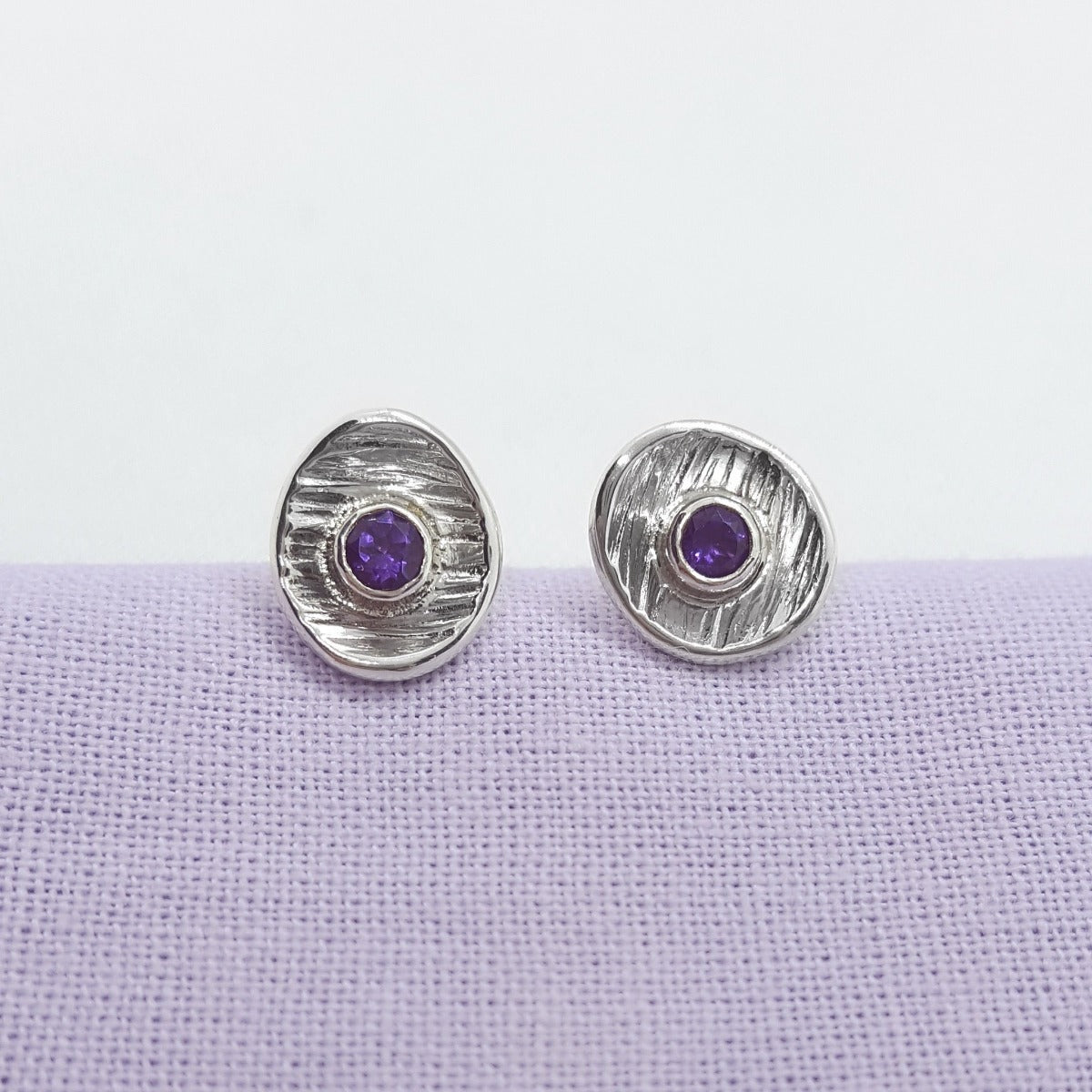 faceted amethyst gemstones set in textured sterling silver cup earrings, handmade jewellery in Kent