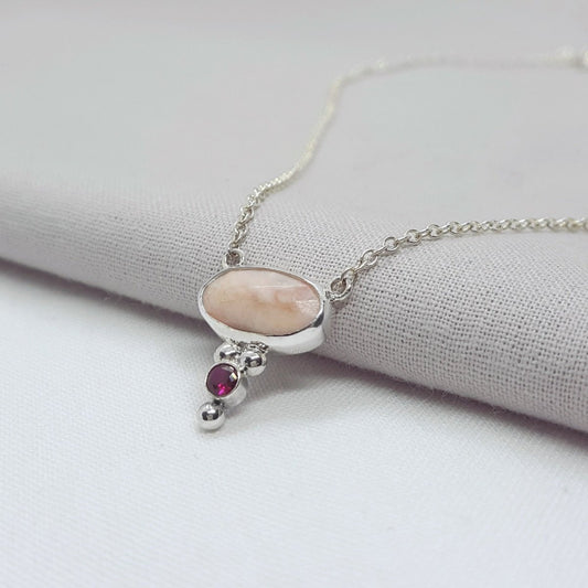 pink opal and lab grown ruby set in a silver necklace. Handmade and one of a kind