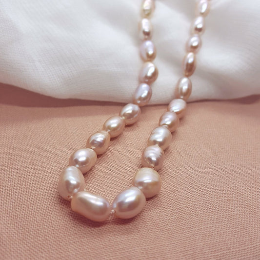 Pink oval pearl necklace, hand knotted on light pink silk thread. Handmade jewellery in the Kent countryside.