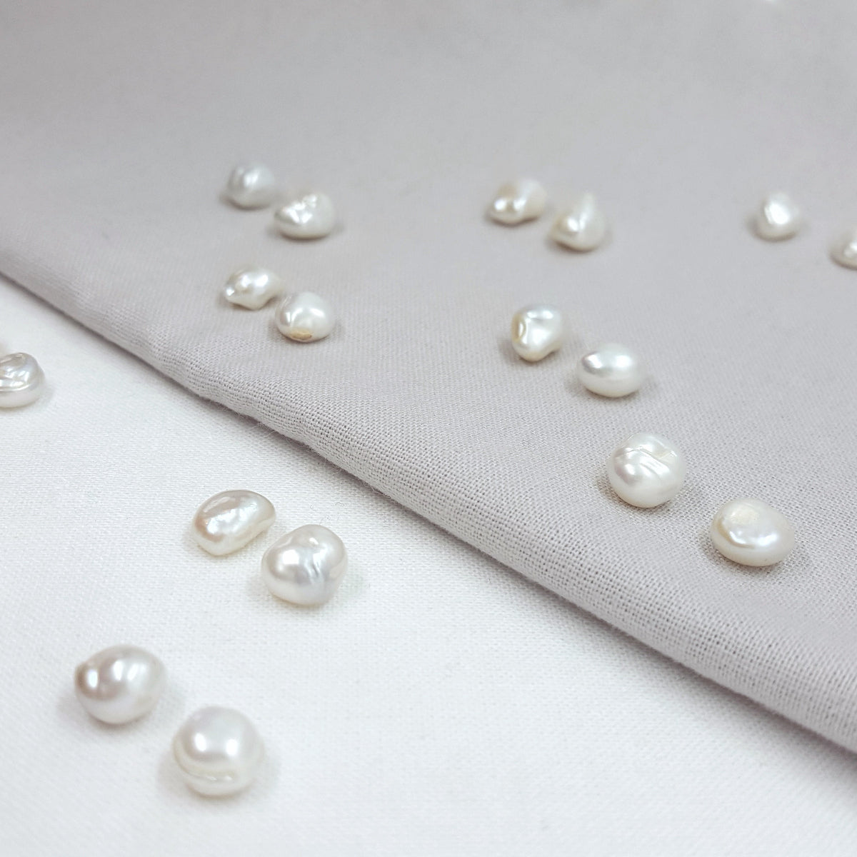 Pearls on a light gray fabric background