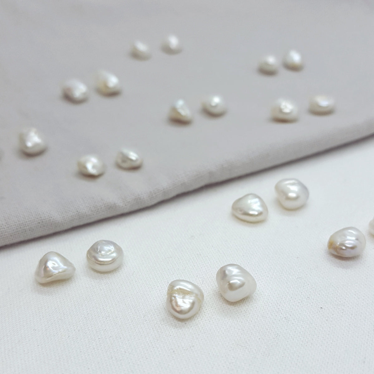 Collection of pearls on a light fabric background