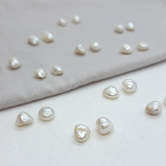 Collection of pearls on a light fabric background