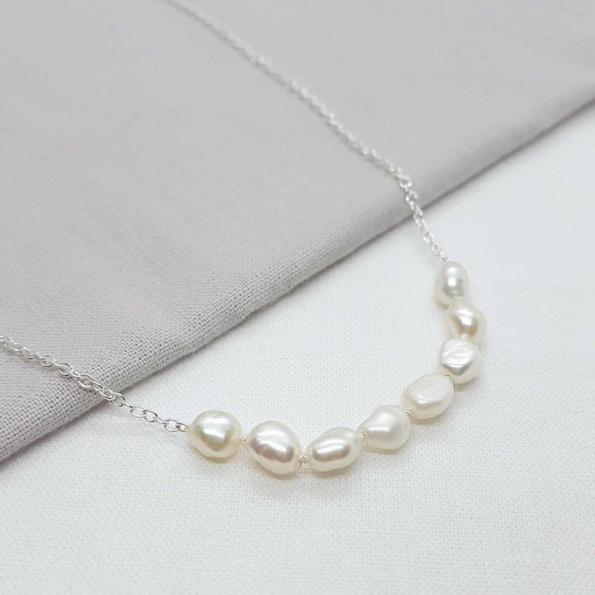 handmade white baroque pearl hand knotted on a silver trace chain 