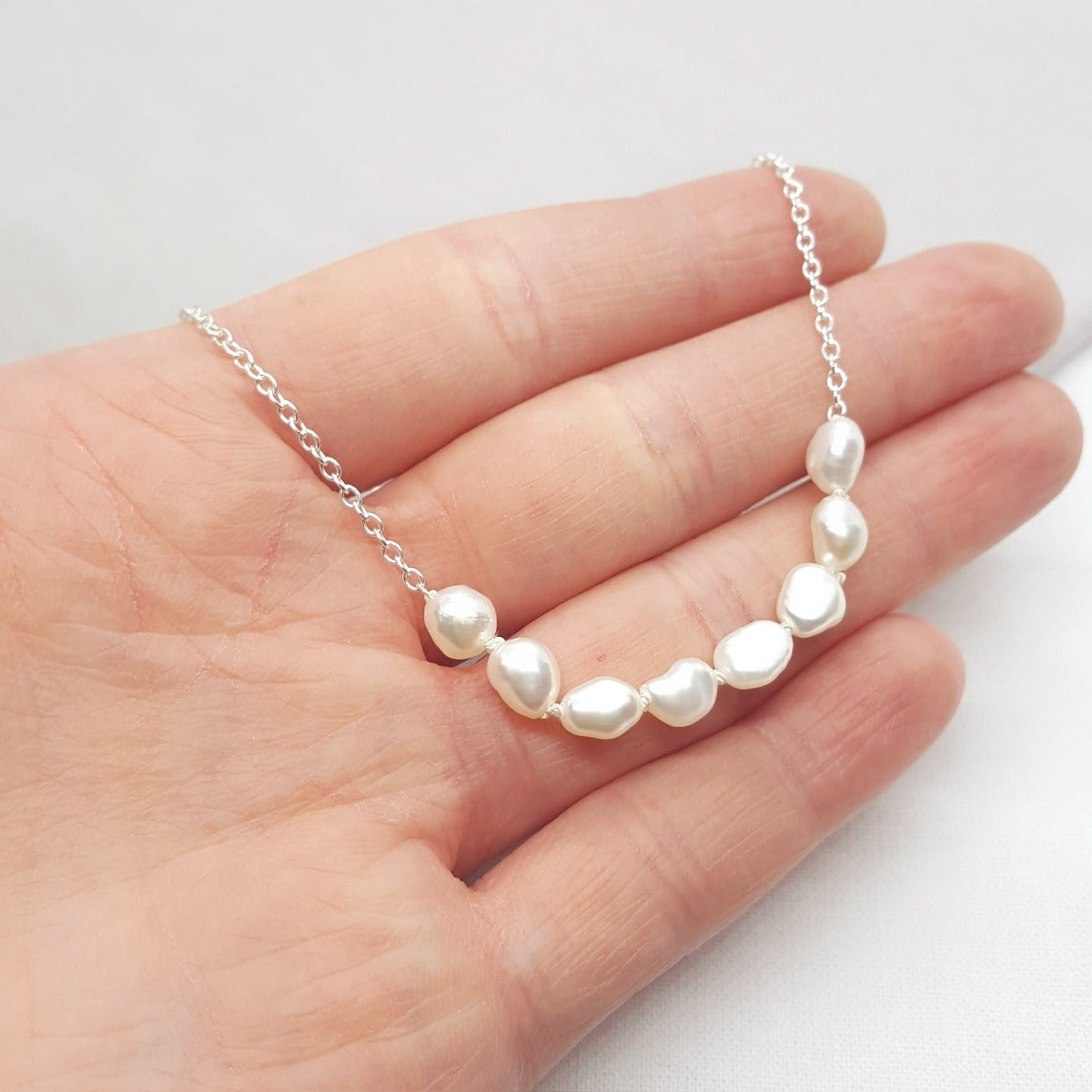 handmade white baroque pearl hand knotted on a silver trace chain 